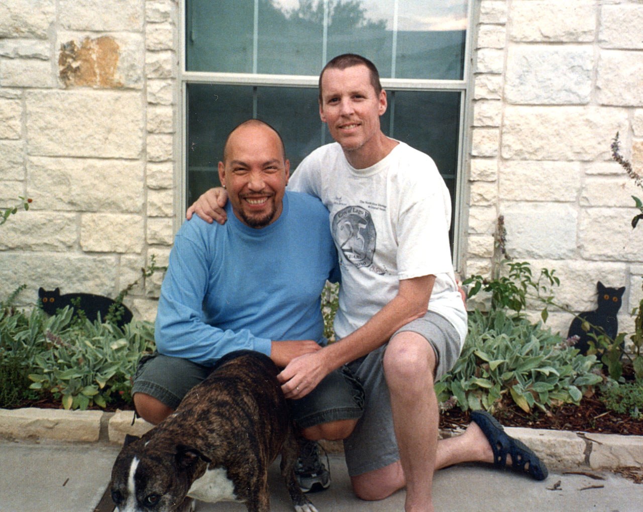 Ladi left and Chris in front of their home