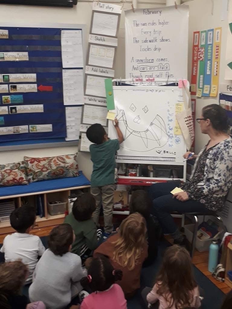 The kindergarten classroom with Devans son at the board